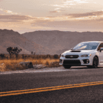 2023 white subaru sedan on the side of a desert road