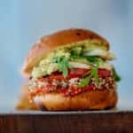 stacked up burger with various ingredients