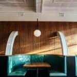 Interior of modern restaurant with leather seats and wooden tables
