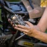 A Person Holding a Carburetor