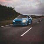 A Rolling Shot of a Blue Subaru on the Road