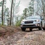 Silver Car Driving on Dirt and Rocky Road
