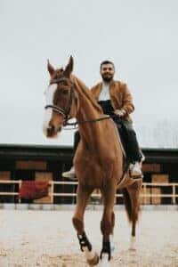 A Bearded Man Riding a Horse