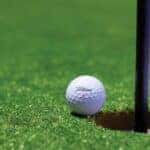 Titrist Golf Ball Near Golf Hole