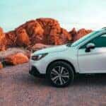 A White Vehicle Parked on Dirt Road