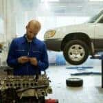 A Man Repairing a Vehicle Motor