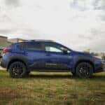 A blue Subaru Crosstrek parked on grass at Huffines Subaru in Corinth, TX