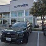 A blue 2026 Subaru Outback parked in front of Huffines Subaru Corinth
