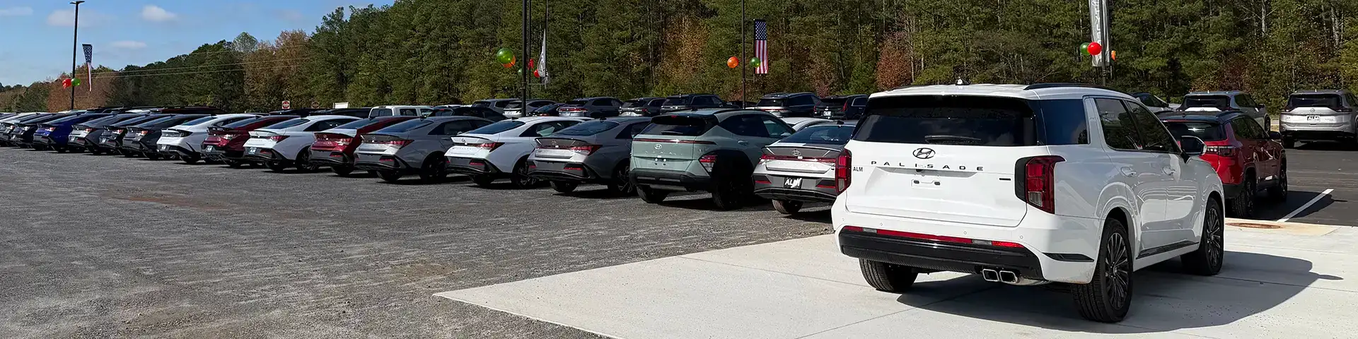 Couple walking next to a red Hyundai sedan
