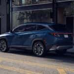 A dark blue 2026 Hyundai Tucson SUV parked on a city street