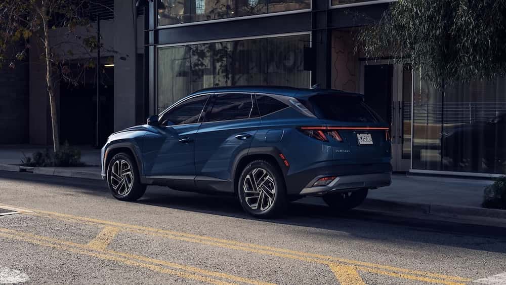 A dark blue 2026 Hyundai Tucson SUV parked on a city street