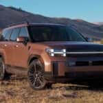 A brown 2026 Hyundai Santa Fe Hybrid SUV with mountains in the background