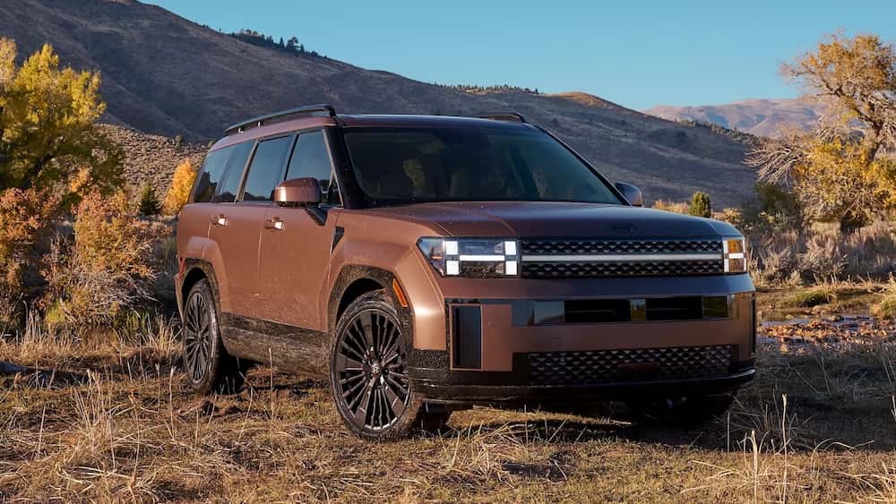 A brown 2026 Hyundai Santa Fe Hybrid SUV with mountains in the background