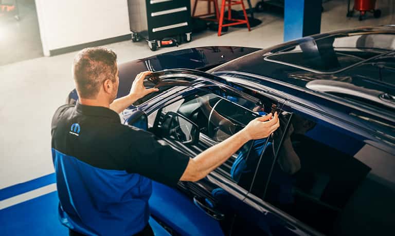 Technician replacing a window
