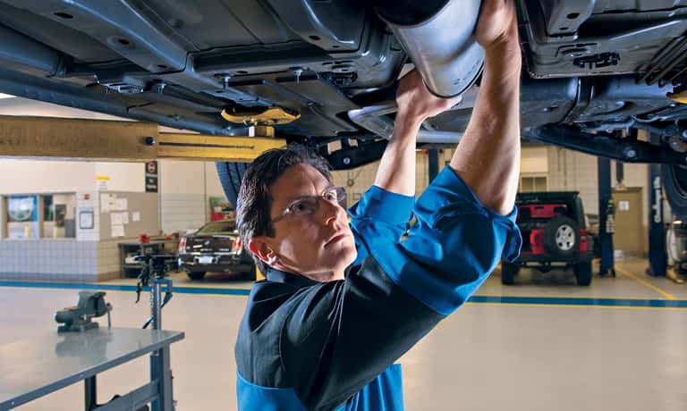 Technician checking exhaust