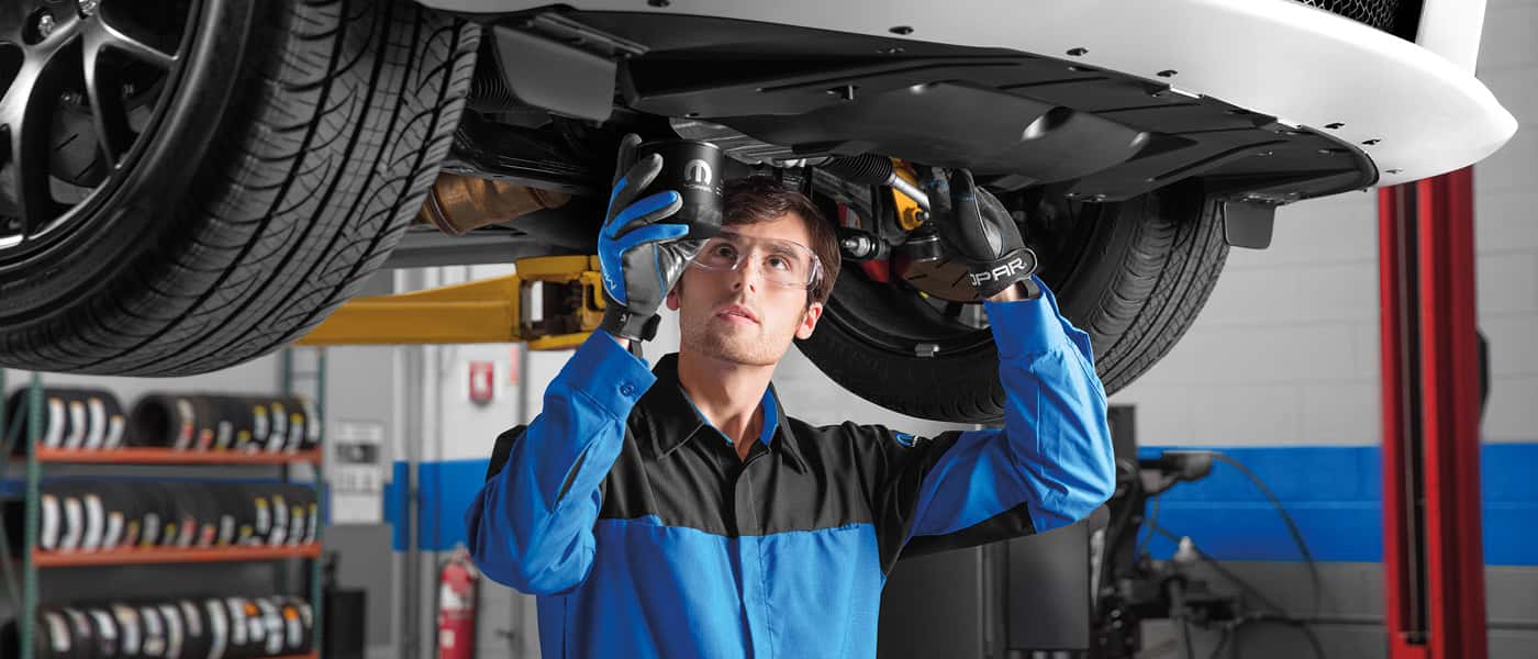 Technician working under a car