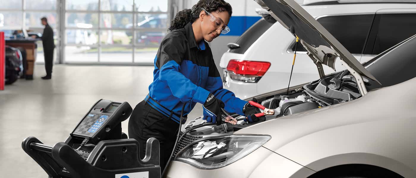 Technician working under hood