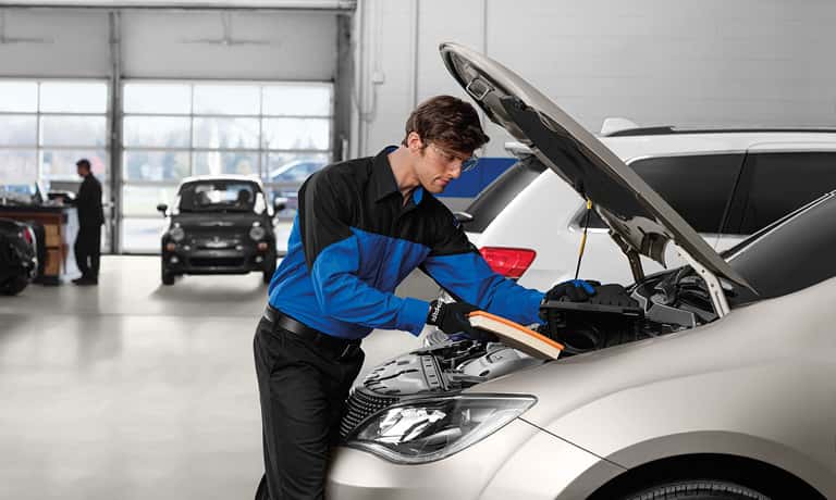 Technician replacing air filter