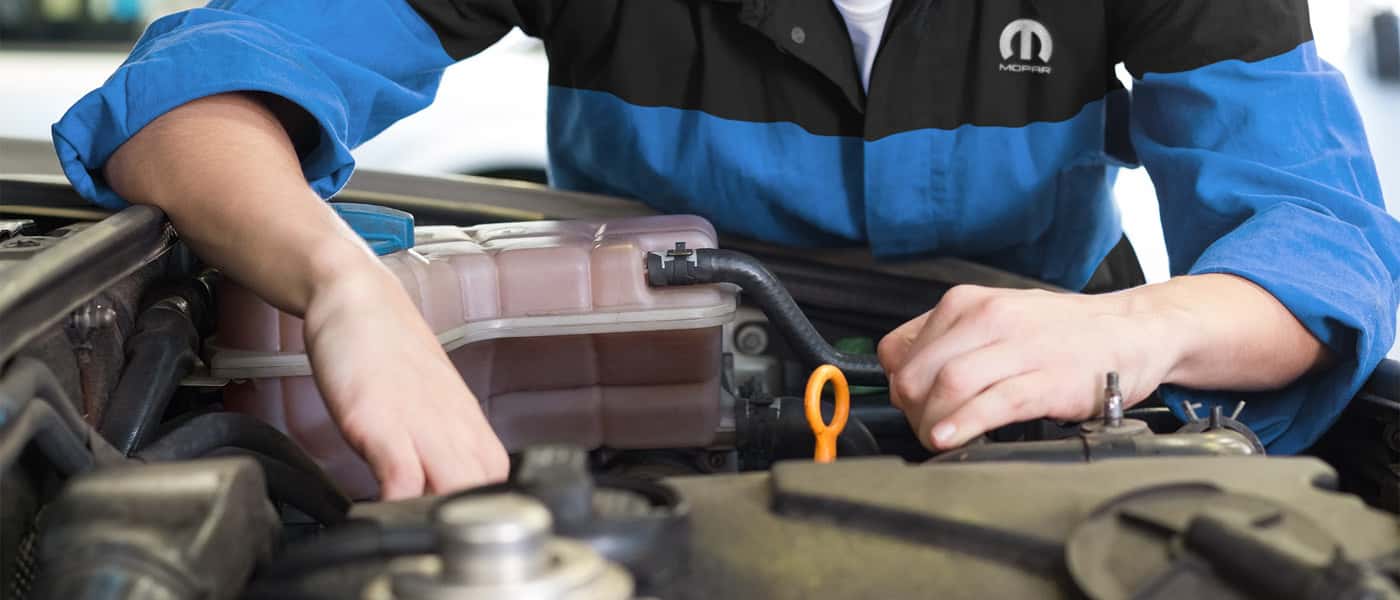 Technician checking under hood
