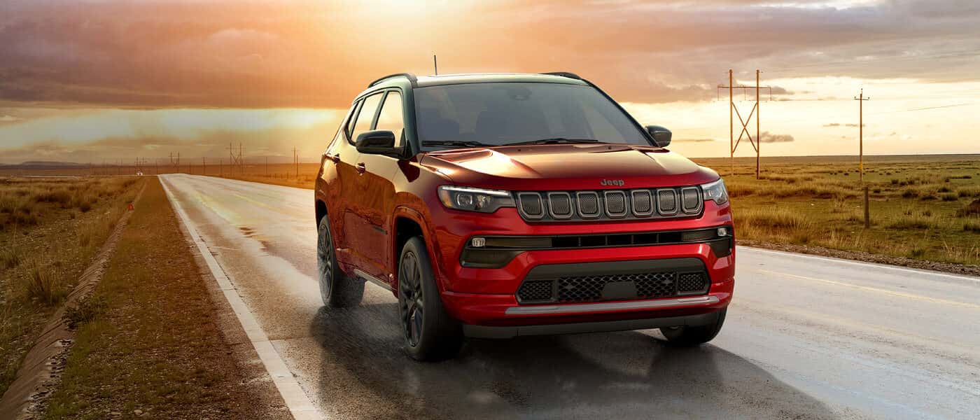 2026 Jeep Compass driving on wet country road