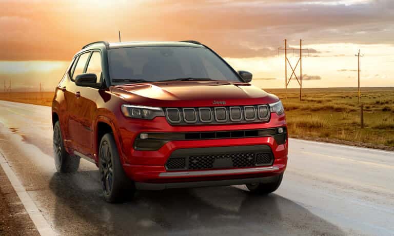 2026 Jeep Compass driving on wet country road