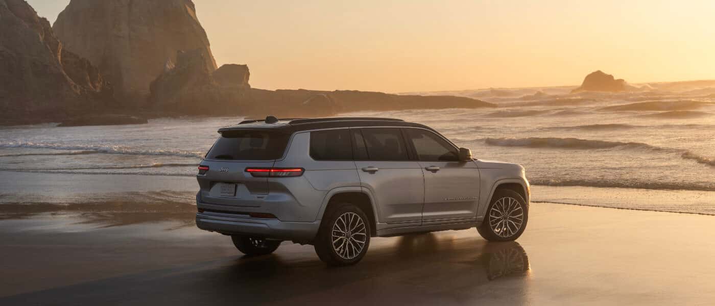 2026 Jeep Grand Cherokee parked facing ocean rocks