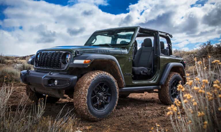 2026 Jeep Wrangler in field with doors off