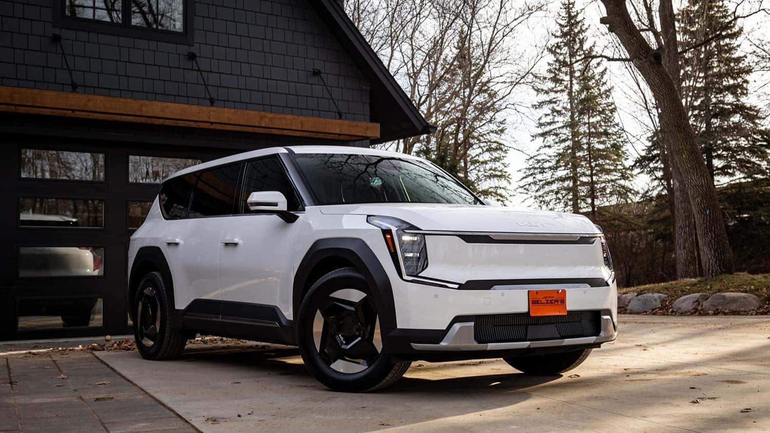 white Kia EV9 in front of a house