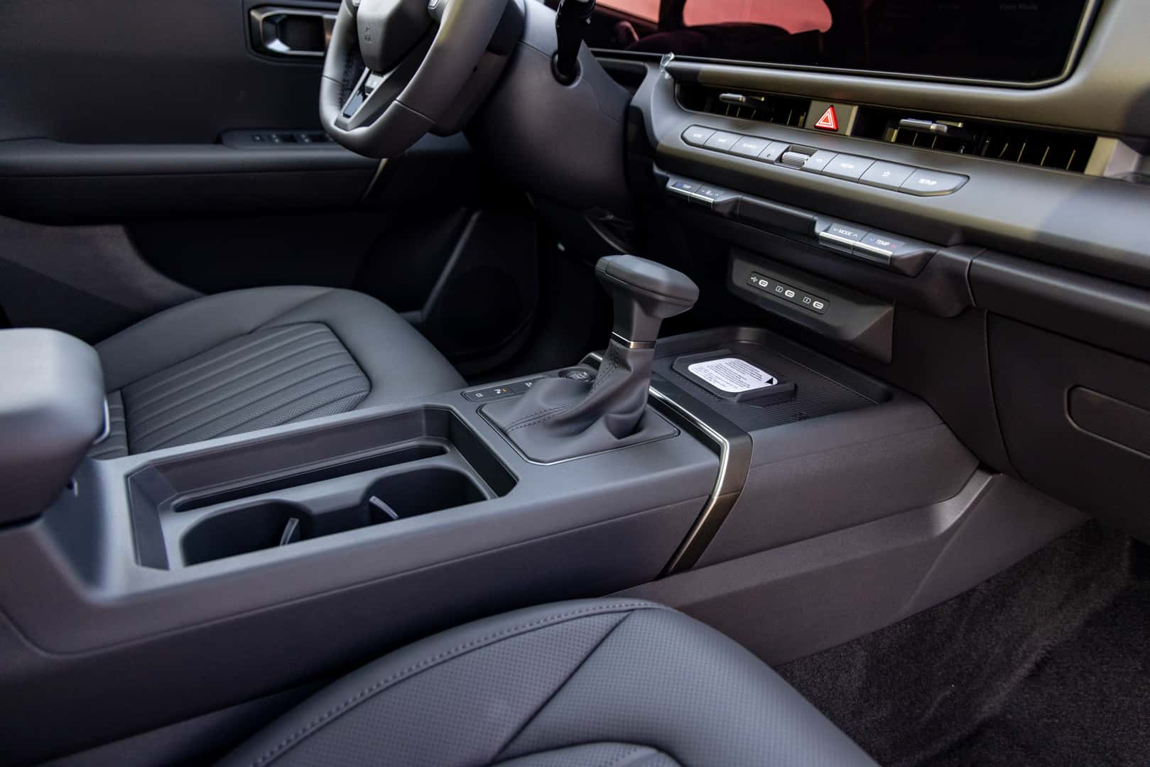 2027 Kia Seltos gear shifter, center console, and cupholders
