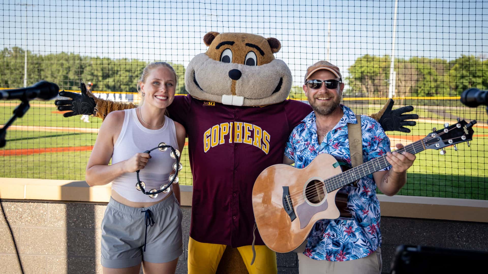 Live band posing with Goldy Gopher at Belzer Stadium