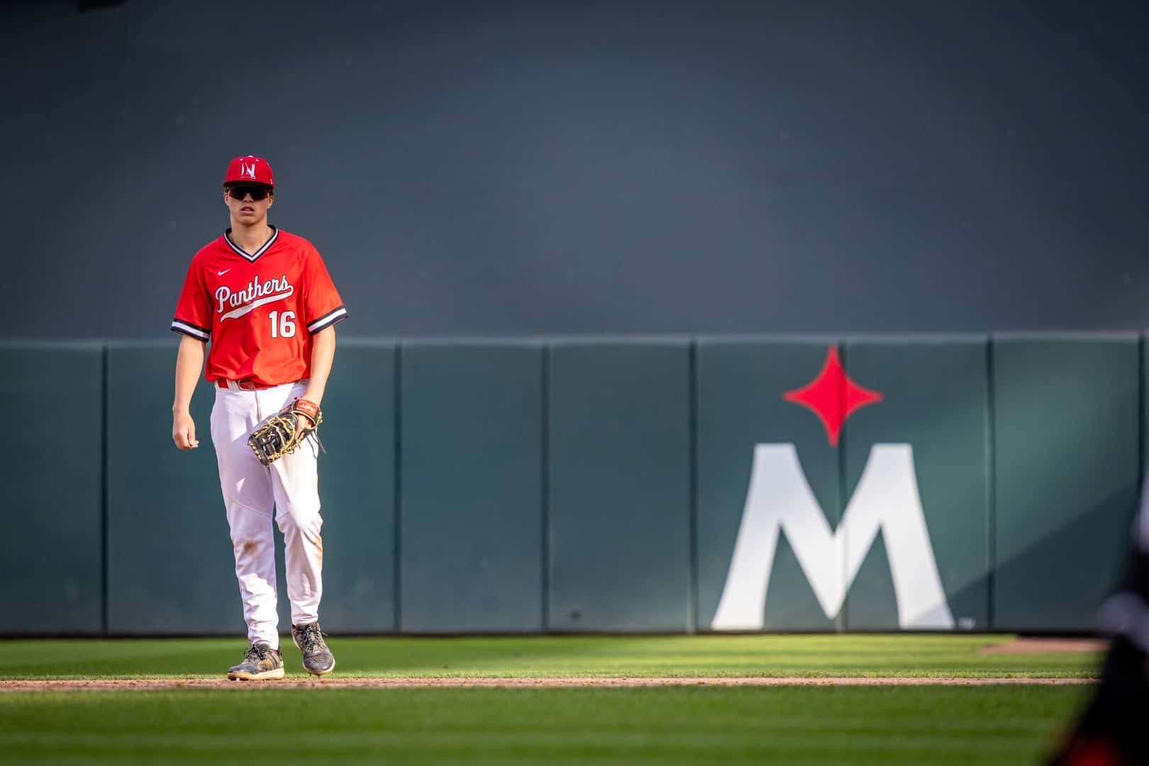 Lakeville North second baseman in position with the Minnesota Twins logo in the background