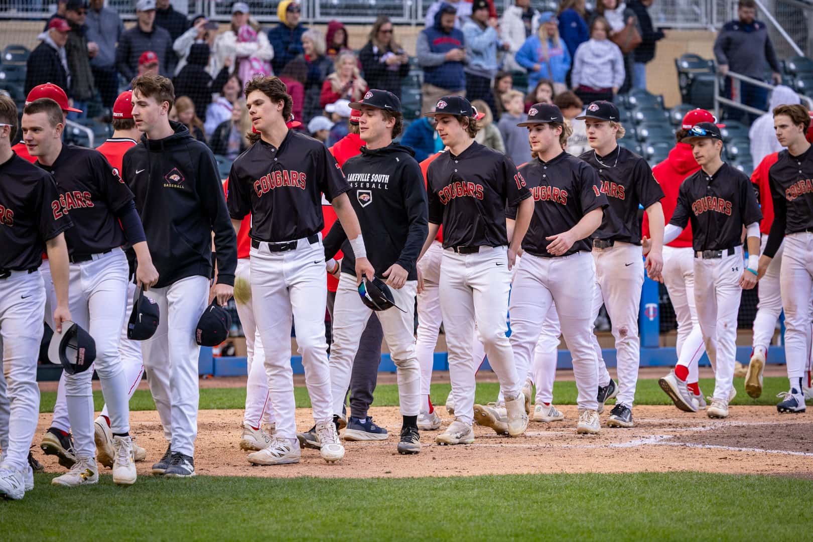 Lakeville North and Lakeville South players shake hands after the game at Target Field