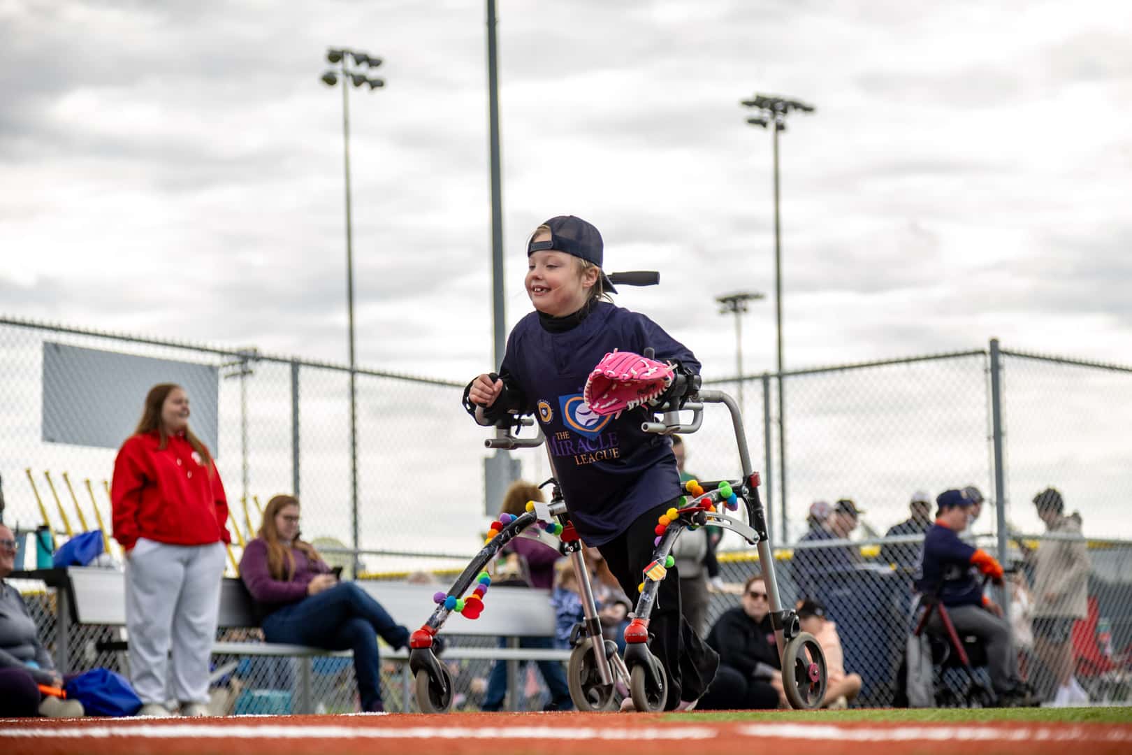 Volunteer buddy supporting an athlete at the Prior Lake Miracle League Field
