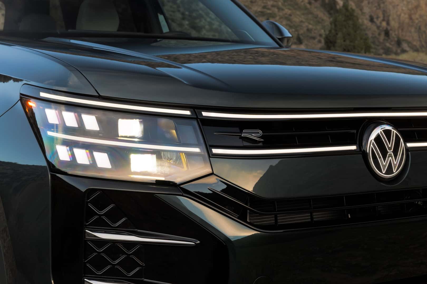 Close-up of the 2027 Atlas double-stacked LED headlight and illuminated VW badge
