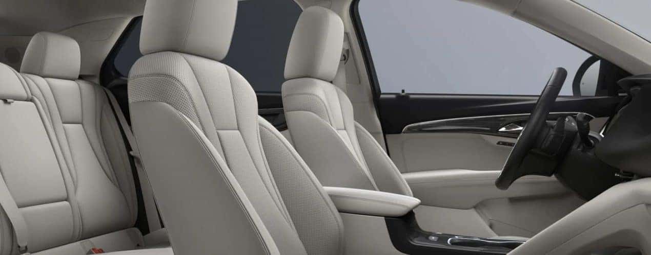 The light grey interior of a 2023 Buick Envision shows the front seating.
