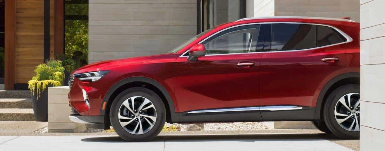 A red 2023 Buick Envision is shown from the side parked in a garage.