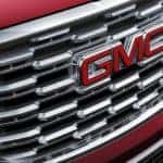A close up shows the chrome grille on a red 2018 GMC Terrain Denali,