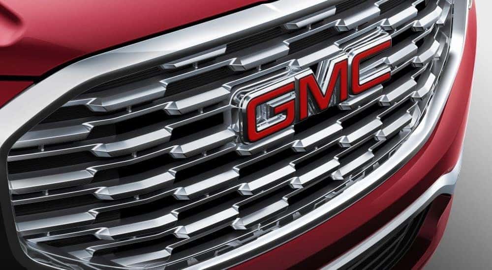A close up shows the chrome grille on a red 2018 GMC Terrain Denali,