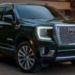 A black 2022 GMC Yukon Denali is shown from the side.