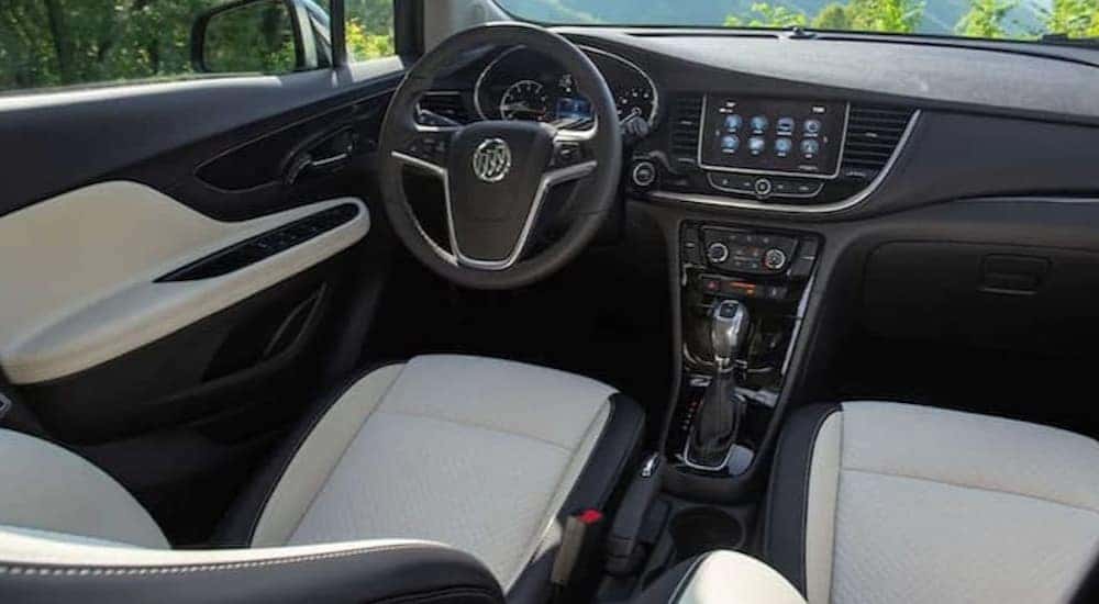 The black and white interior and dash of a 2021 Buick Encore is shown.