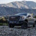 A grey 2024 GMC Sierra 1500 AT4X AEV is shown from the front at an angle.