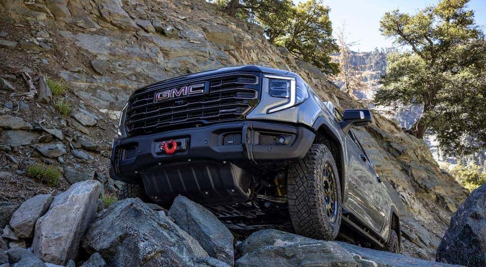 A grey 2023 GMC Sierra 1500 AT4x AEV is shown from the front at an angle after leaving a dealer that has a GMC Sierra 1500 for sale.