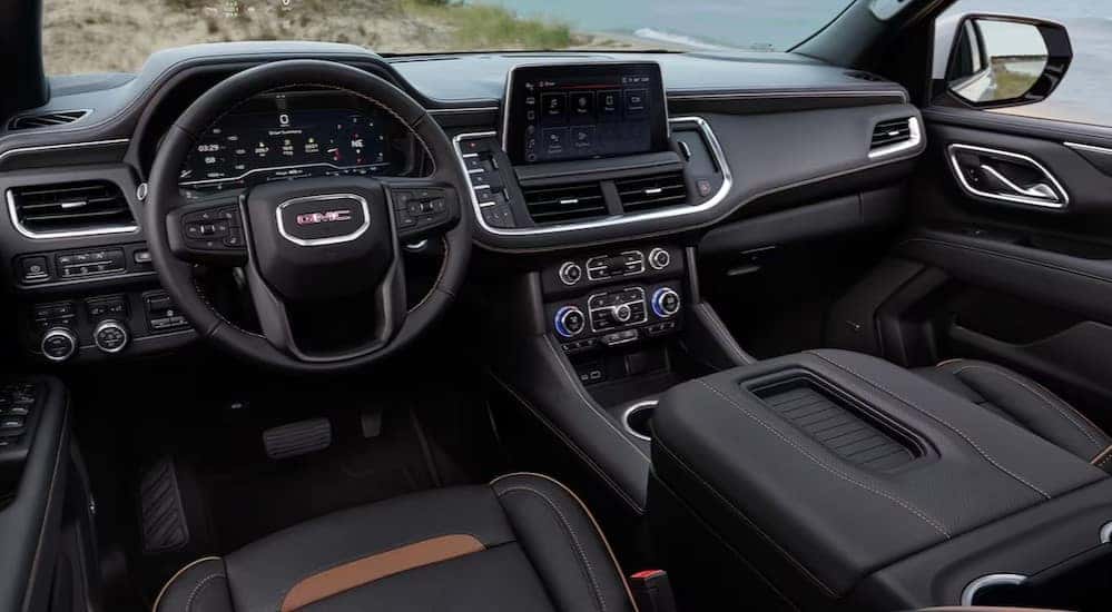 The black interior and dash of a 2024 GMC Yukon XL is shown.