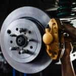 Close-up of a mechanic performing brake service.