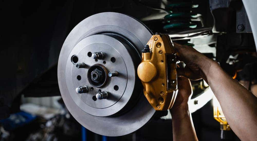 Close-up of a mechanic performing brake service.
