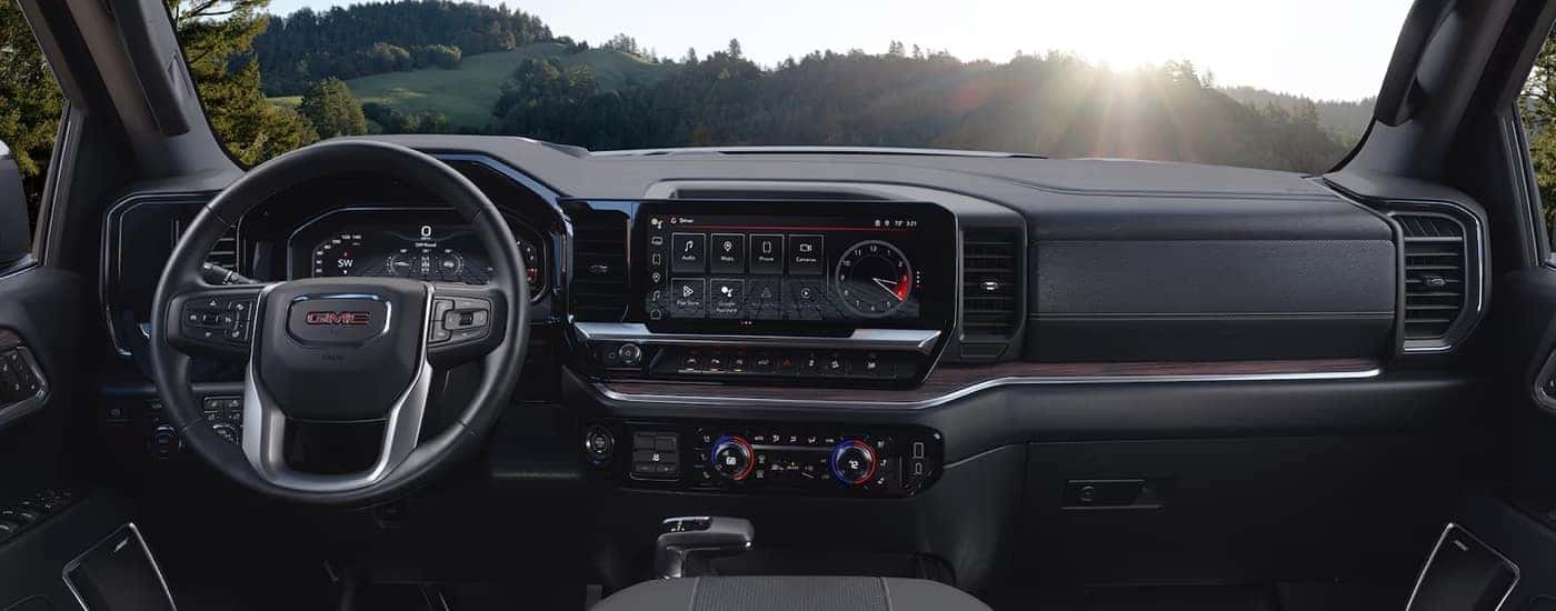 The cabin and dashboard of a 2024 GMC Sierra 1500, a truck for sale.