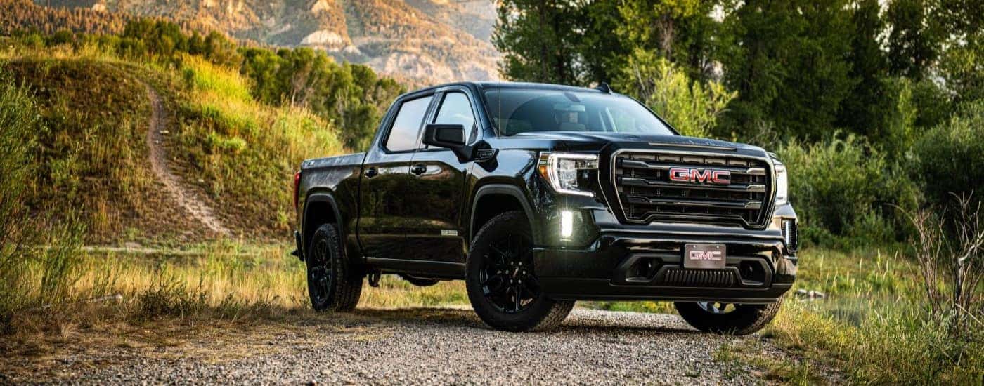 A black 2020 GMC Sierra 1500 SLE Elevation parked off-road.