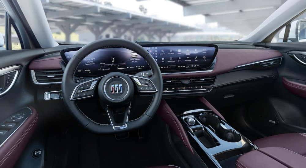 The black and red interior and dash are shown in a 2025 Buick Envision.