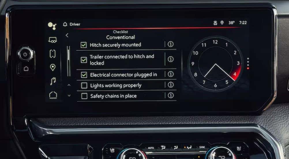 A close-up of the infotainment screen is shown in a 2025 GMC Sierra for sale.