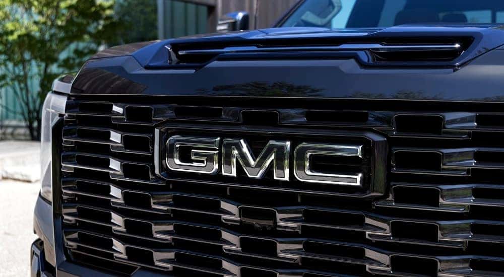 A close up shows the grille on a black 2025 GMC Sierra 2500 for sale.